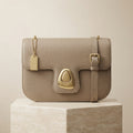 Moncrief Beige Pebble Clasp Crossbody bag